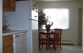 Taylor apartment for rent - a kitchen with a table and chairs and a refrigerator