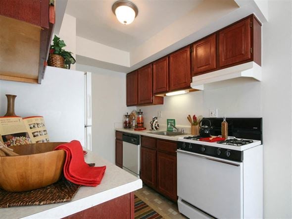 Taylor townhouse for rent - A kitchen with a white stove and wooden cabinets.