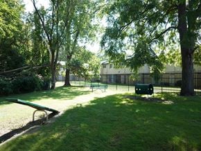 Taylor townhouse for rent - A park with a green bench and a green trash can.