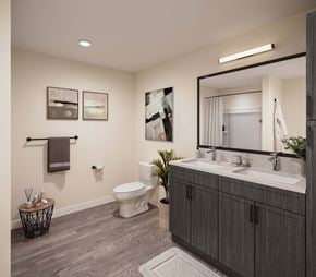 Reno townhouse for rent - A bathroom with a toilet, sink, and mirror at The Village at Hawk View, Reno, 89512.