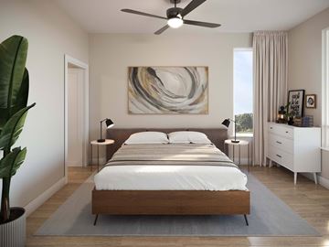 Reno townhouse for rent - A modern bedroom with a large bed and a painting on the wall.