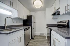Aurora apartment for rent - a kitchen with white cabinets and a sink and a refrigerator