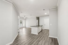 Jonesboro apartment for rent - A spacious kitchen with white cabinets and a wooden floor.