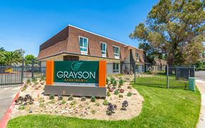 Rancho Cordova apartment for rent - a green and orange sign in front of a brick building