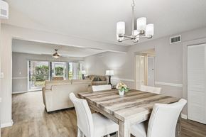 Orlando apartment for rent - A dining room with a wooden table and white chairs.