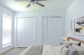 Charleston apartment for rent - a bedroom with a bed and a ceiling fan