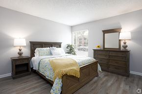 Orlando apartment for rent - a bedroom with a bed and dressers and a window