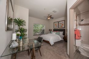 Jonesboro apartment for rent - a bedroom with a bed and a glass desk