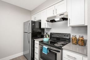 Beaverton apartment for rent - a kitchen with white cabinets and stainless steel appliances