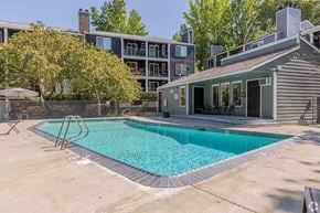 Beaverton apartment for rent - A swimming pool in a backyard with a house in the background.