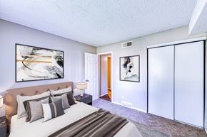 Aurora apartment for rent - a bedroom with a large bed and sliding glass doors