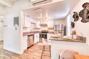 Edgewater apartment for rent - a kitchen with white cabinets and stainless steel appliances
