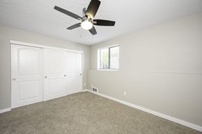 Beaverton apartment for rent - a bedroom with a ceiling fan and two closets