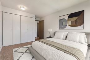 Northglenn apartment for rent - A bedroom with a large bed and a painting on the wall.