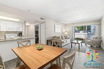 West Bradenton apartment for rent - A well-lit apartment living room with a dining table and chairs.