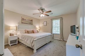 Knoxville apartment for rent - a bedroom with a bed and a ceiling fan