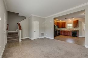 Knoxville apartment for rent - an empty living room with a kitchen and a staircase