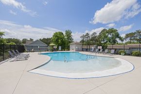 Knoxville apartment for rent - our apartments have an outdoor pool with chairs and trees