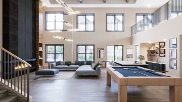 Knoxville apartment for rent - A large room with a pool table and a staircase.
