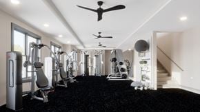 Knoxville apartment for rent - a gym with exercise equipment and a ceiling fan