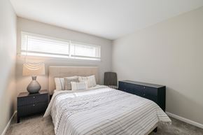 Birmingham apartment for rent - A bedroom with a bed, nightstand, and window.