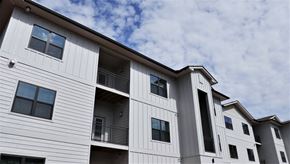 Knoxville apartment for rent - the exterior of a multifamily building with a cloudy sky in the background