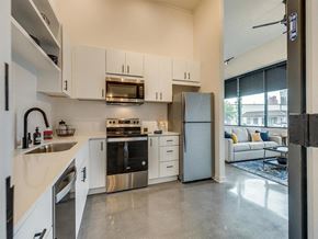 Knoxville apartment for rent - a kitchen with white cabinets and a stainless steel refrigerator
