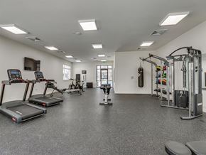 Knoxville apartment for rent - a gym with cardio equipment and weights in a building