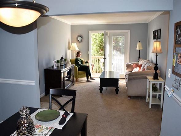 Knoxville apartment for rent - a woman sitting on a couch in a living room