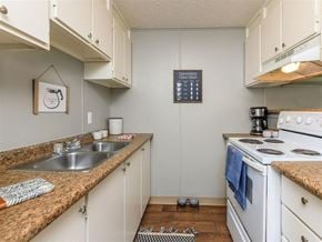 Knoxville apartment for rent - a kitchen with white appliances and counter tops and a sink