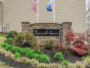 Knoxville apartment for rent - the front of a building with a sign and flags
