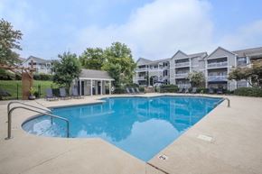 Chattanooga apartment for rent - A swimming pool in front of a building with a gazebo.
