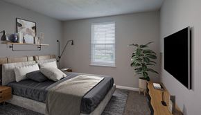 Madison apartment for rent - A bedroom with a bed, a nightstand, a chair, a plant, and a TV mounted on the wall.