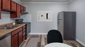Madison apartment for rent - A kitchen with brown cabinets and a black chair.
