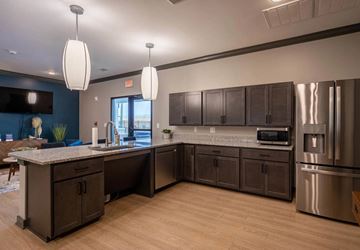 Hixson apartment for rent - A kitchen with dark brown cabinets and stainless steel appliances.