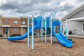 Norton Shores apartment for rent - A blue and white playground slide in a residential area.