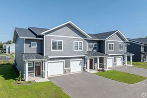 Allendale Charter Twp apartment for rent - A large, modern house with a grey exterior and a spacious driveway.