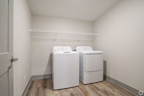 Allendale Charter Twp apartment for rent - Two white front loading washing machines in a laundry room.