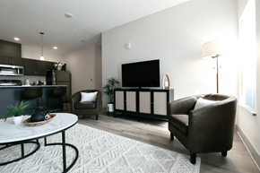 Norton Shores apartment for rent - A modern living room with a white coffee table and brown leather couch.
