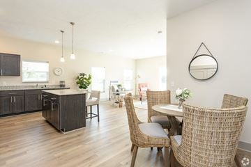 Hudsonville apartment for rent - A modern kitchen with a dining table set for two.