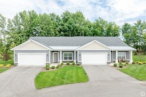 Hudsonville apartment for rent - A two-car garage is attached to a house.