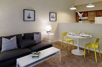 Baltimore apartment for rent - a living room with a couch and a table and chairs