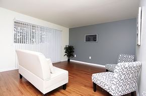 Baltimore apartment for rent - a living room with a white couch and two chairs