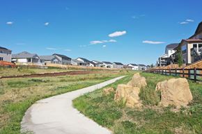 Watkins apartment for rent - a path leading to a row of houses on a field