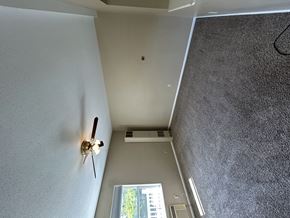 Groton apartment for rent - A ceiling fan is mounted on a white wall in a room with a window.