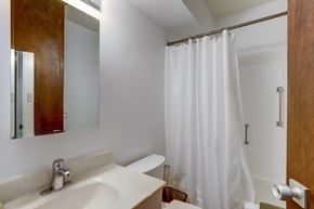 Boulder apartment for rent - a bathroom with a shower and a sink and a mirror