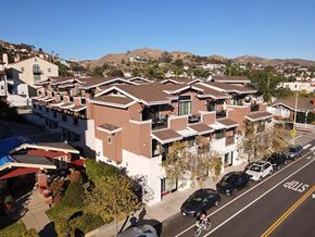 Ventura condo for rent - A residential street with houses on both sides and cars parked on the side of the road.