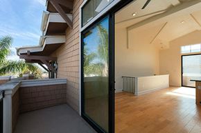 Ventura apartment for rent - A balcony with a glass door leading to a room with wooden floors.
