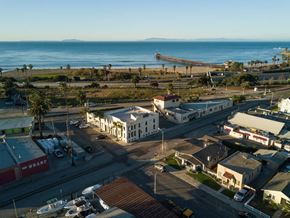 Ventura apartment for rent - A view of a beachfront area with a pier extending into the water.