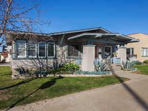 Ventura apartment for rent - A house with a blue roof and a green lawn.